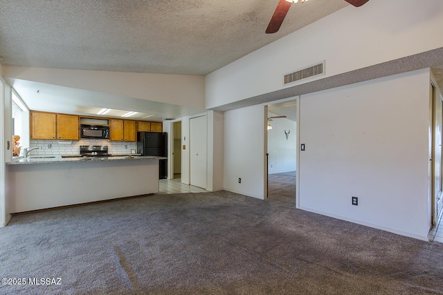 unfurnished living room featuring sink, high vaulted ceiling, light carpet, a textured ceiling, and ceiling fan