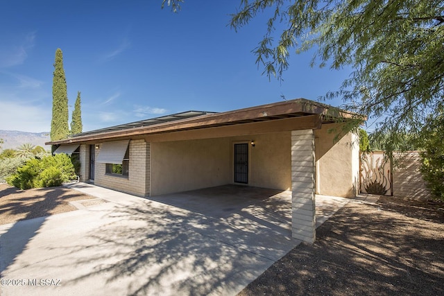 back of property with a carport