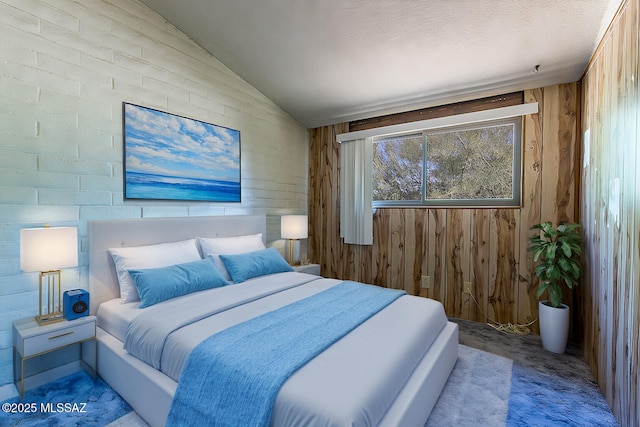 carpeted bedroom with wooden walls and vaulted ceiling