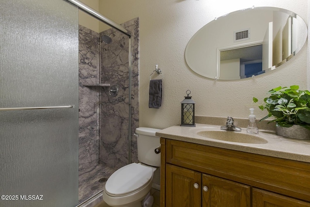 bathroom with vanity, toilet, and an enclosed shower