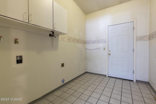 washroom with electric dryer hookup, light tile patterned floors, hookup for a washing machine, and cabinets