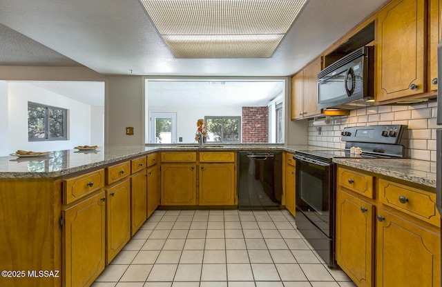 kitchen with sink, tasteful backsplash, black appliances, light tile patterned flooring, and kitchen peninsula