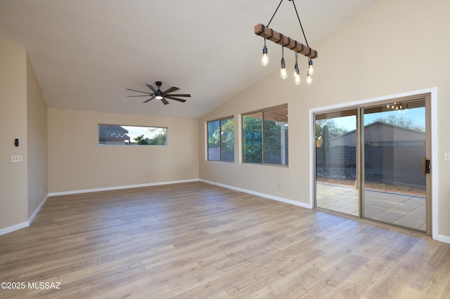 interior space with vaulted ceiling, ceiling fan, and light hardwood / wood-style flooring