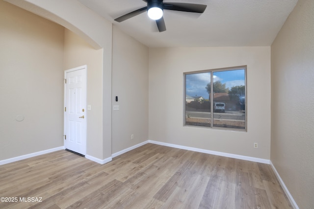 unfurnished room featuring vaulted ceiling, ceiling fan, and light hardwood / wood-style flooring