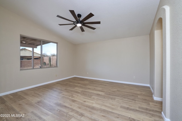 unfurnished room featuring lofted ceiling, light hardwood / wood-style floors, and ceiling fan