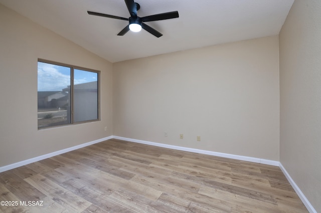 spare room with light hardwood / wood-style flooring, ceiling fan, and vaulted ceiling