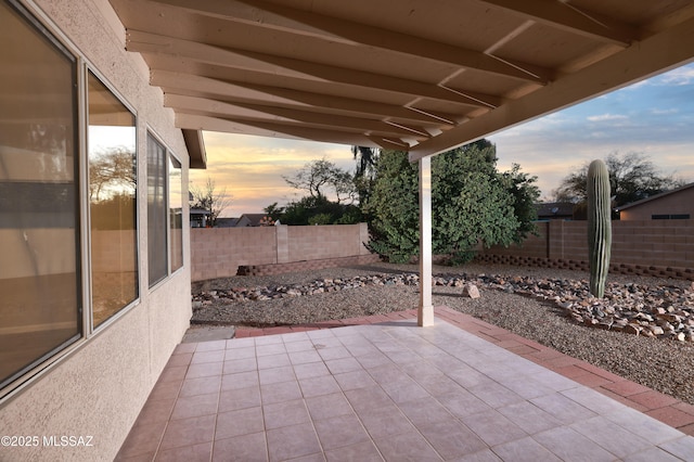 view of patio terrace at dusk