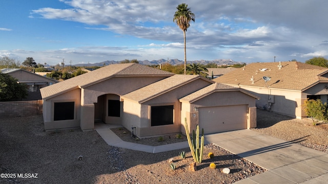 ranch-style home with driveway, stucco siding, a garage, and a mountain view