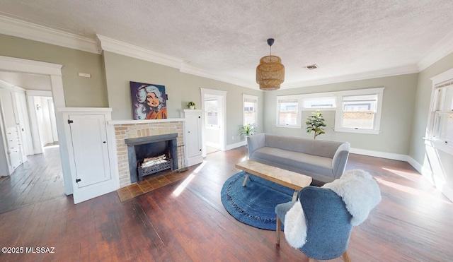 living room featuring crown molding, a brick fireplace, hardwood / wood-style flooring, and a textured ceiling