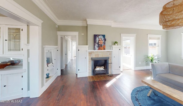 living room with a brick fireplace, crown molding, wood-type flooring, and a textured ceiling