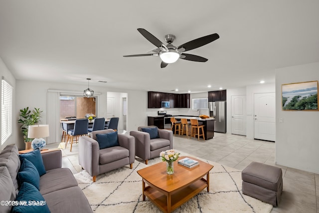 living area with recessed lighting and ceiling fan