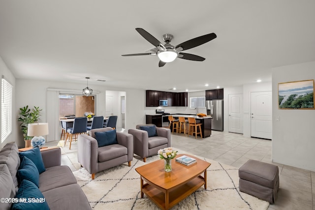 tiled living room with ceiling fan