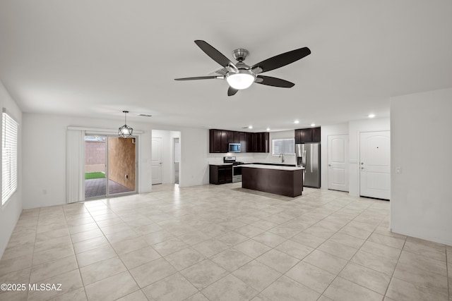 unfurnished living room with ceiling fan and light tile patterned floors