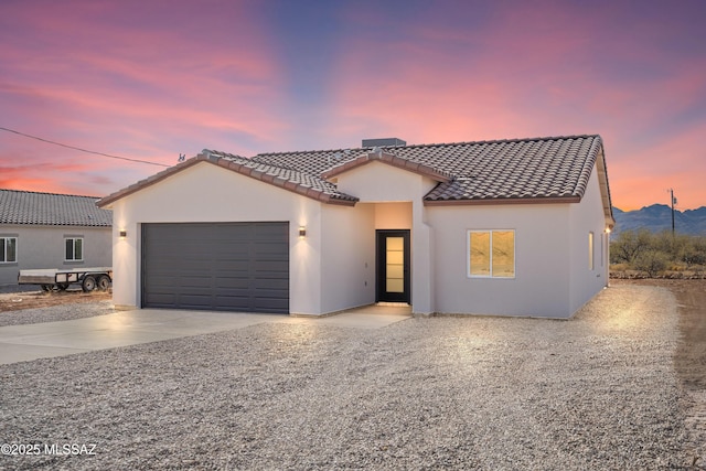 mediterranean / spanish home featuring a garage