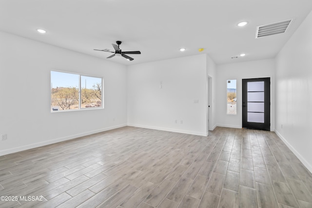 unfurnished room featuring ceiling fan and light wood-type flooring