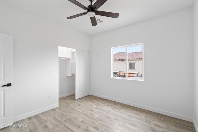 unfurnished bedroom featuring light hardwood / wood-style floors, a closet, and ceiling fan