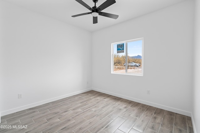 empty room featuring ceiling fan and light wood-type flooring