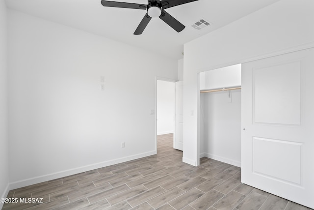 unfurnished bedroom with ceiling fan and a closet