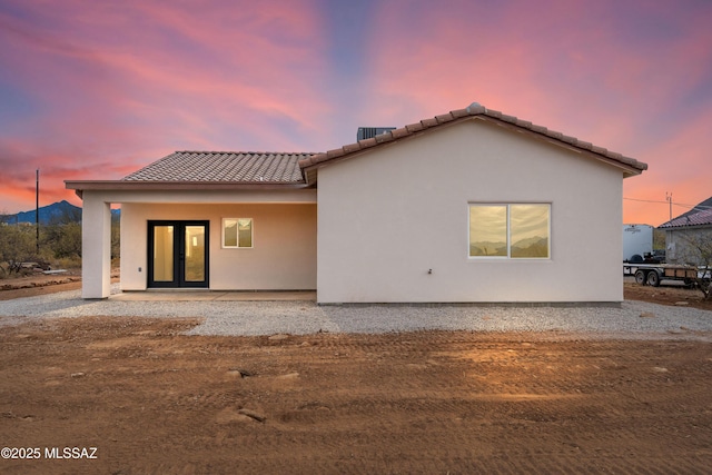 back house at dusk with french doors