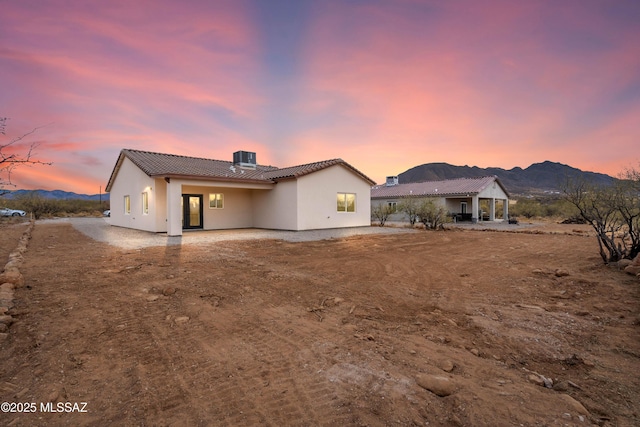 back house at dusk with a mountain view