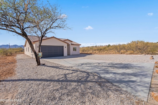 view of front of home featuring a garage and a mountain view