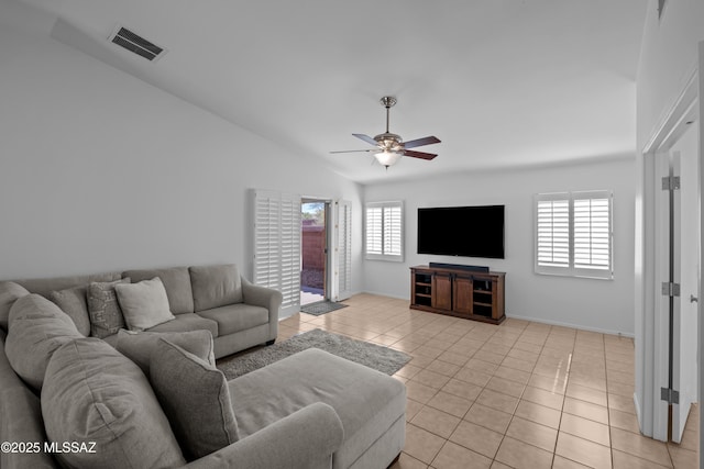 tiled living room featuring lofted ceiling, a wealth of natural light, and ceiling fan