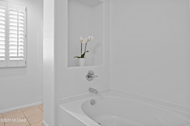 bathroom featuring tile patterned flooring and a tub to relax in