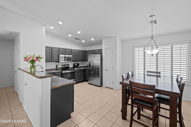 kitchen with visible vents, lofted ceiling, gray cabinetry, appliances with stainless steel finishes, and light tile patterned floors