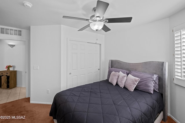 bedroom featuring a closet, ceiling fan, and carpet flooring