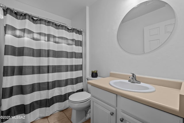 bathroom with tile patterned flooring, vanity, walk in shower, and toilet