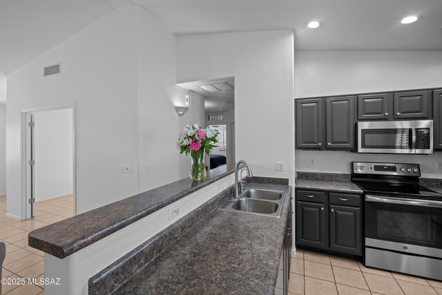 kitchen featuring lofted ceiling, sink, beverage cooler, kitchen peninsula, and stainless steel appliances