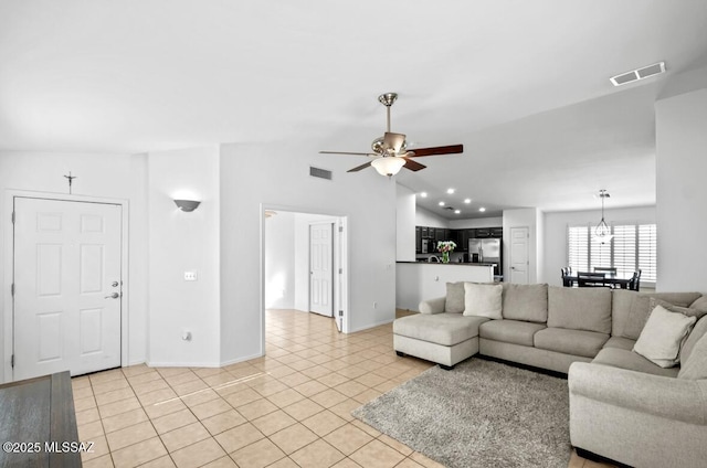living room with light tile patterned floors, lofted ceiling, visible vents, and ceiling fan with notable chandelier
