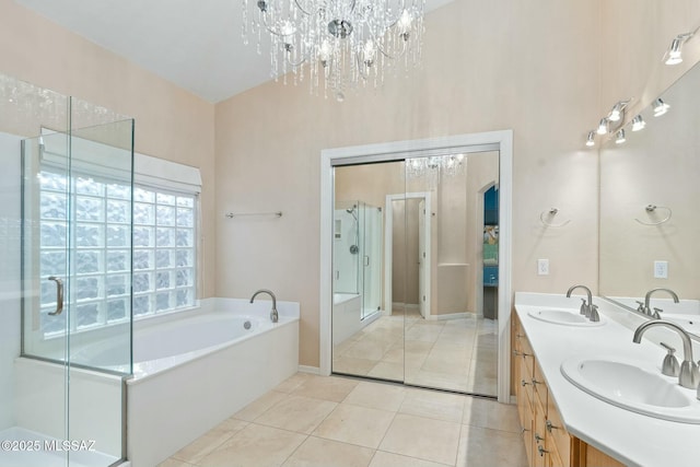 bathroom with tile patterned flooring, vanity, and plus walk in shower