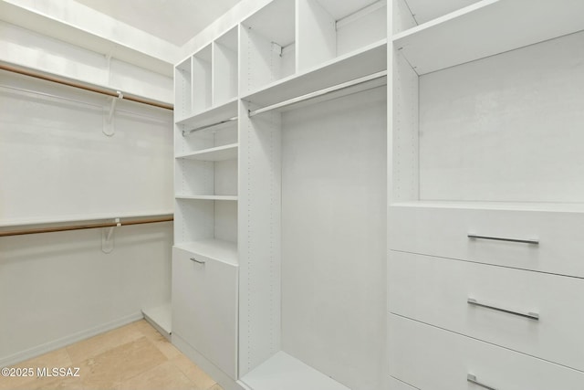 walk in closet featuring light tile patterned floors