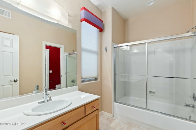 bathroom with vanity, tile patterned floors, and shower / bath combination with glass door