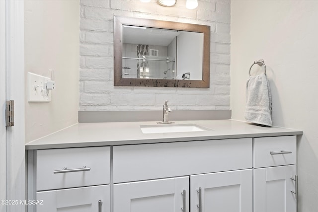 bathroom with vanity and a shower with shower door