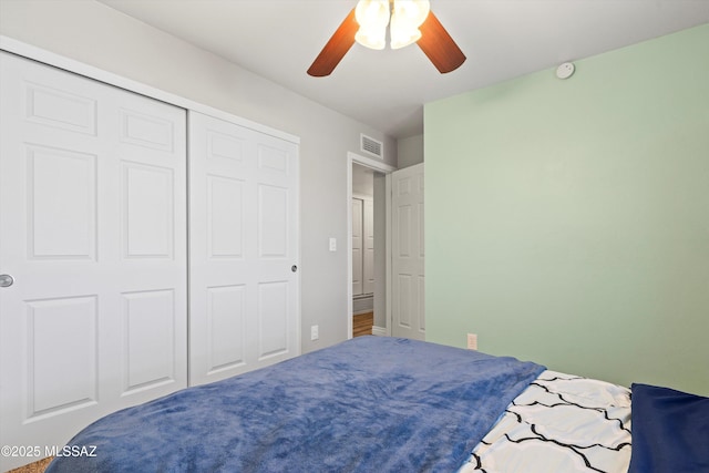 bedroom with ceiling fan and a closet