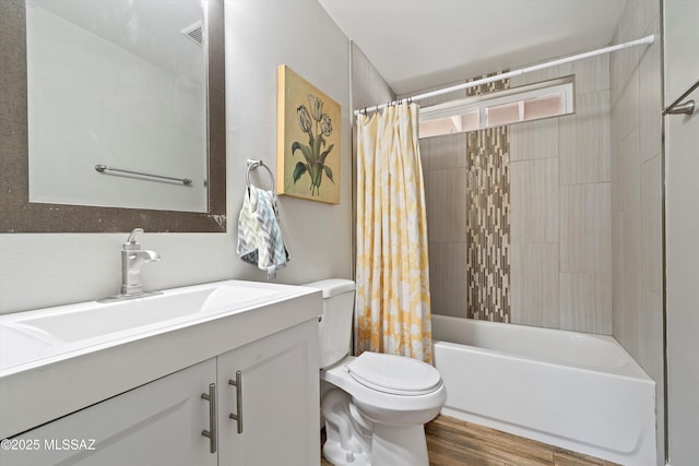 full bathroom featuring shower / tub combo with curtain, hardwood / wood-style floors, vanity, and toilet