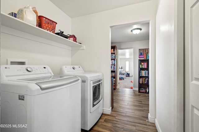 clothes washing area featuring dark wood-type flooring and washing machine and dryer