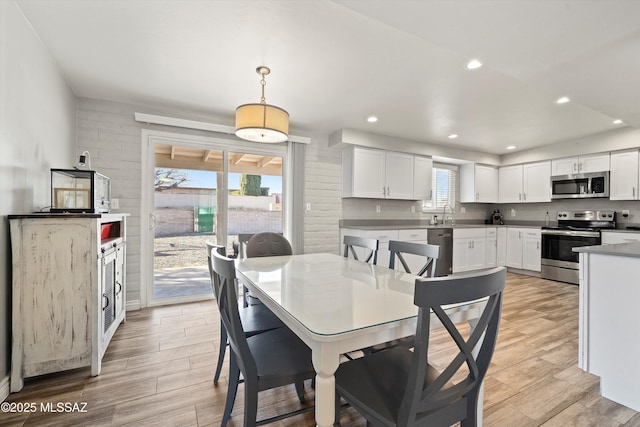 dining room with sink and plenty of natural light