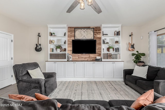 living room with built in shelves and ceiling fan