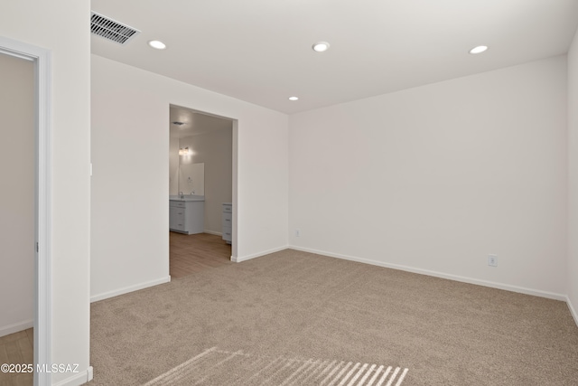 empty room featuring light colored carpet