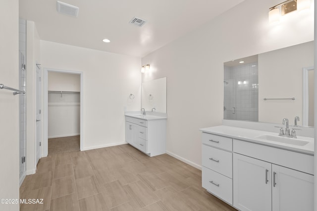 bathroom with vanity and a shower with door