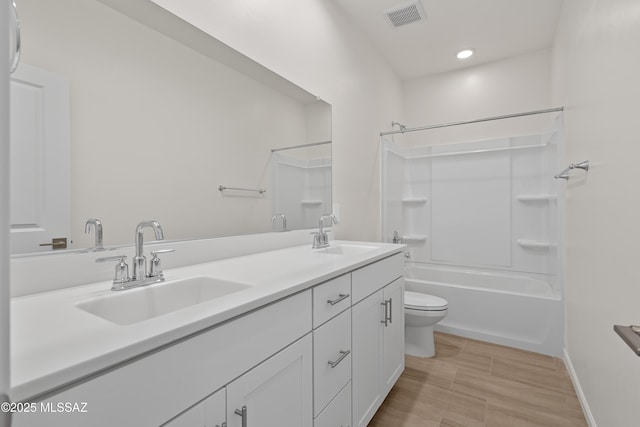 full bathroom featuring vanity, shower / bathtub combination, and toilet