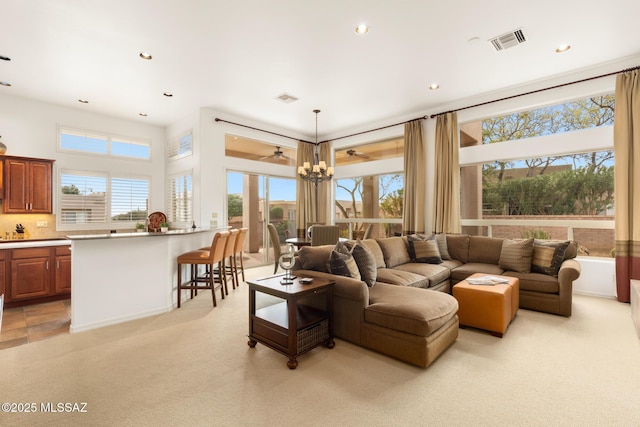 living area featuring light carpet, visible vents, and recessed lighting