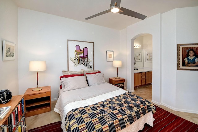 bedroom featuring light carpet, ceiling fan, and ensuite bathroom