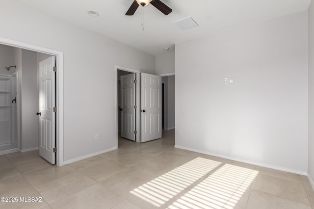 tiled bedroom featuring a spacious closet and ceiling fan