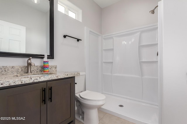 bathroom featuring walk in shower, tile patterned floors, vanity, and toilet