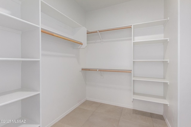 walk in closet featuring tile patterned flooring