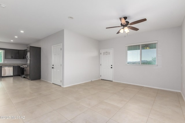 tiled spare room with ceiling fan